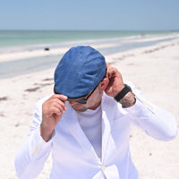 man in blue Genova Cotton Italian Cap on the beach