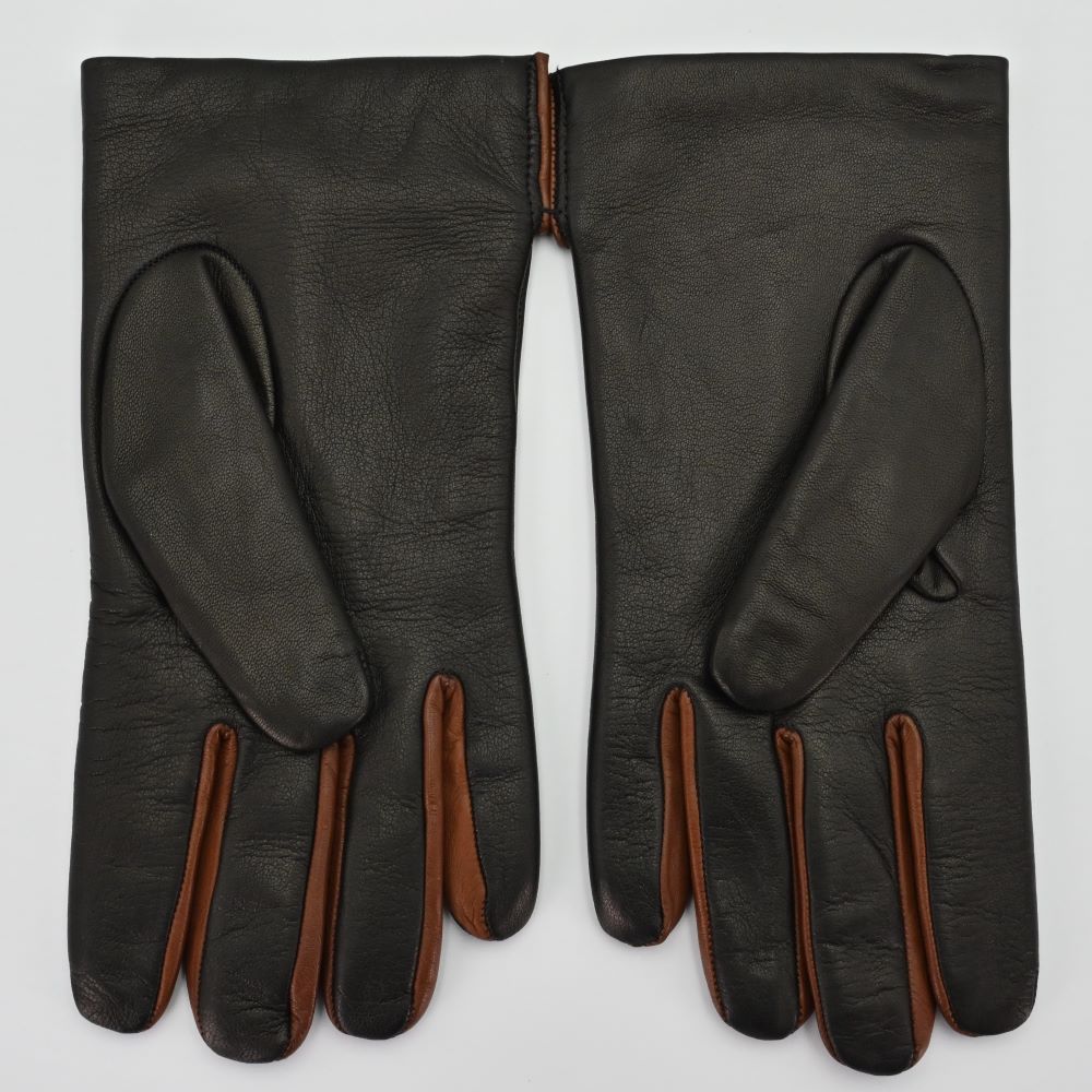 Back view of black leather gloves with brown accents between the fingers, highlighting their premium craftsmanship.