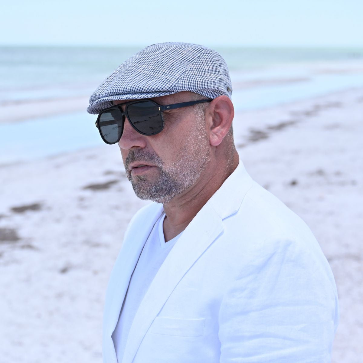 man in navy Paulo Linen Cap on the beach