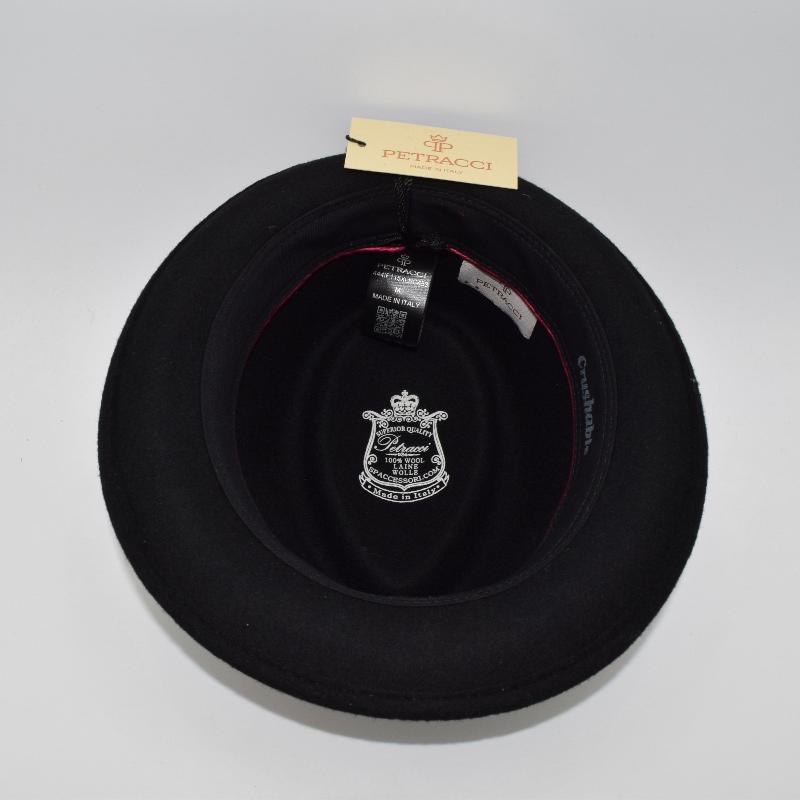 Interior view of a black alpine hat with a 'Petracci' tag and branding, showcasing the 100% wool construction, quality craftsmanship, and 'Made in Italy' label.