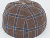 Back/top view of a brown plaid baseball cap featuring blue and beige checkered patterns with a seamless design, showcasing the fabric button at the crown and structured panels.