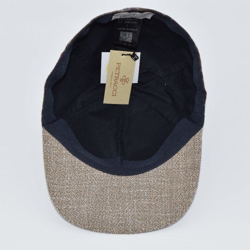 Interior view of a brown plaid baseball cap with a textured beige brim, featuring a black lining and a 'Petracci' tag, highlighting its Made in Italy craftsmanship.