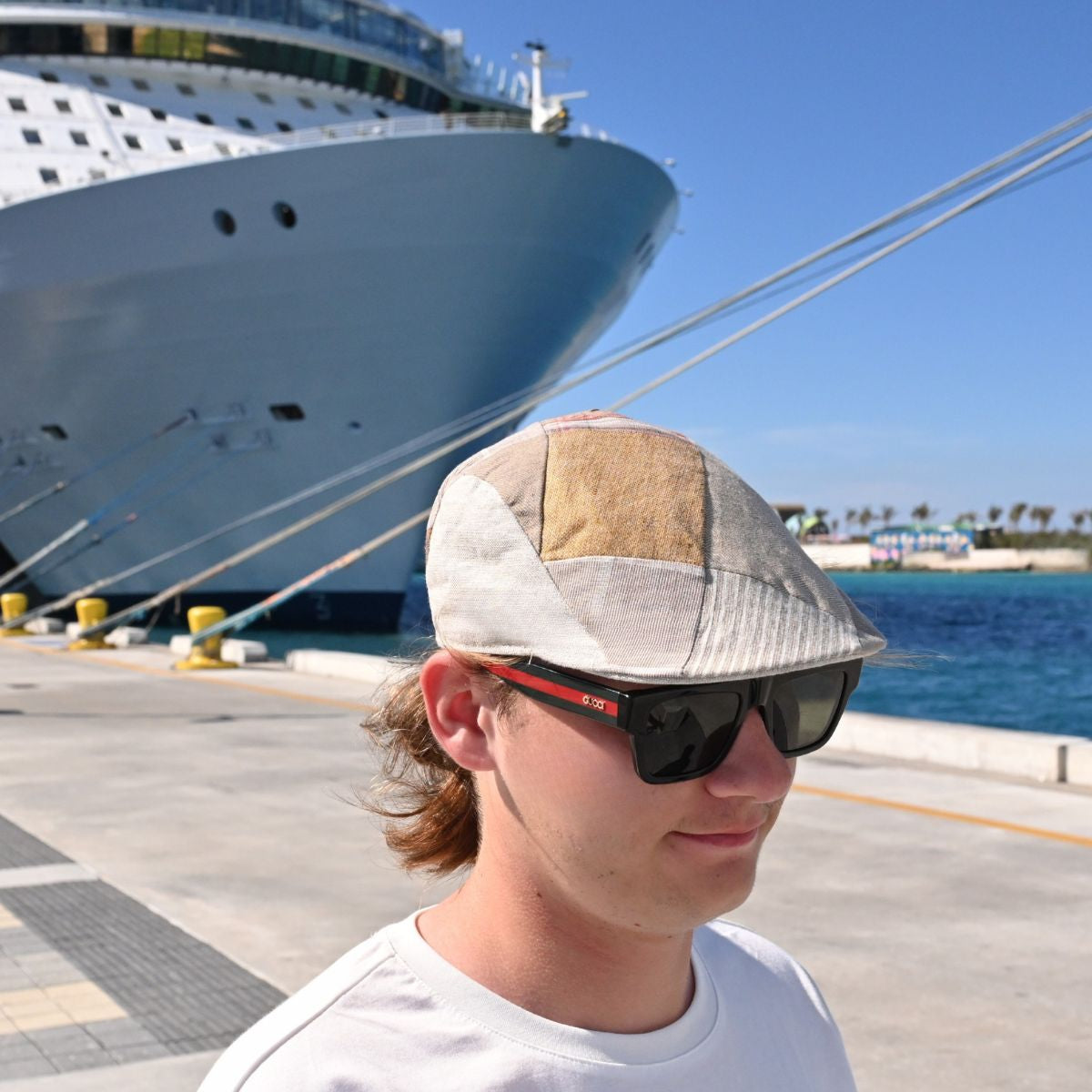 Model in Beige Patchwork Cap with cruise ship in background