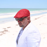 Man in Italian Red Rosso Linen Cap with beach in background