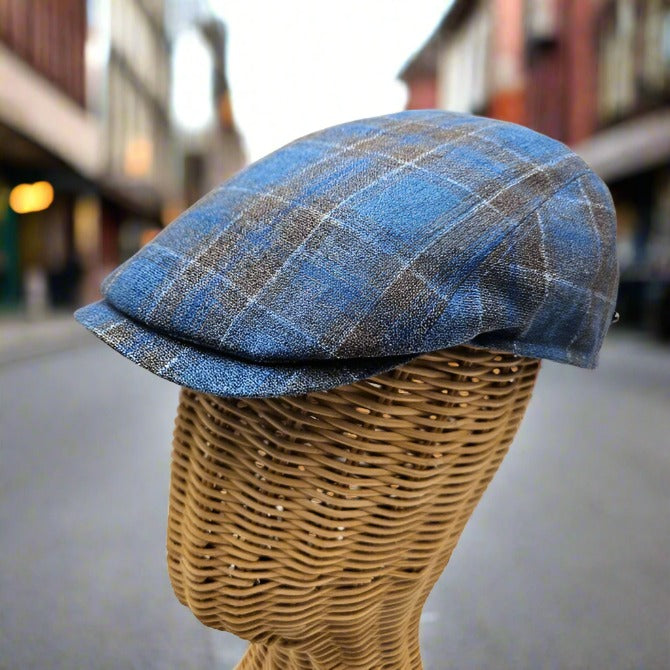 black and blue Silk Cup on mannequin with blurred buildings in the background 