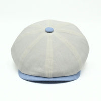 Ivory Salerno Linen Newsboy Hat with blue visor and button on white background