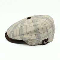 Beige Bartolomeo linen cotton newsboy hat with plaid pattern and leather visor on white background