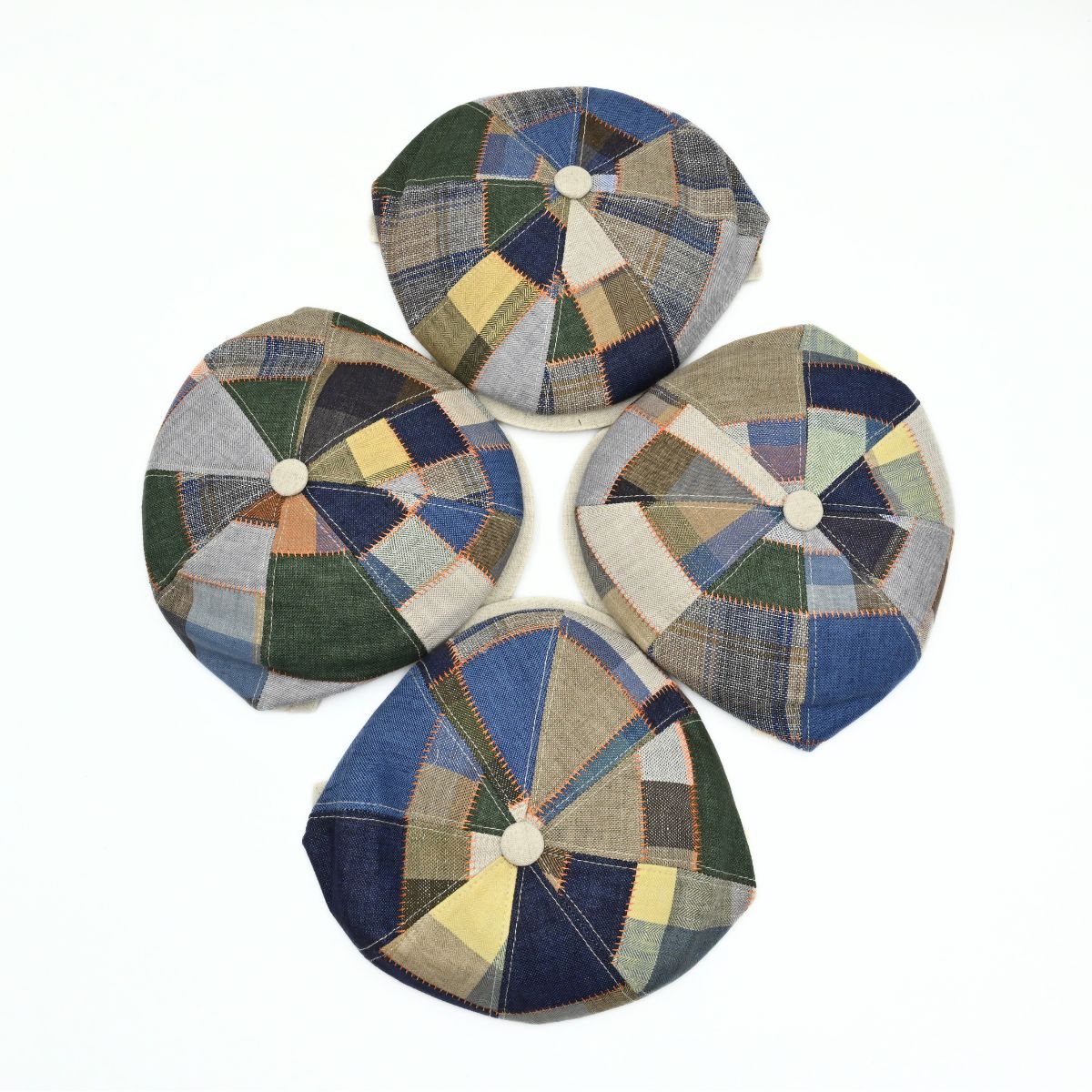 Four Multicolor Italian Patchwork Newsboy Hats on white background