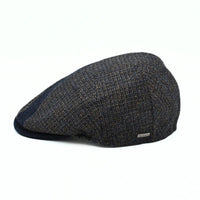 Side view of the Bergamo Cap showing navy and tweed patchwork wool panels