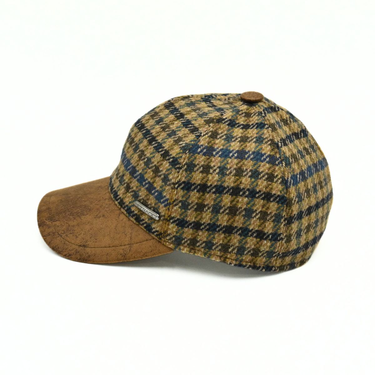 Bolzano Heritage Wool Baseball Cap featuring a brown and navy blue plaid pattern on the crown, with a textured brown visor and a small metal brand tag on the side, set against a plain white background.