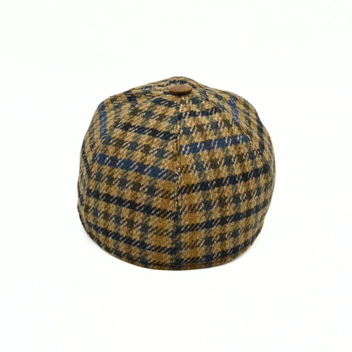 Bolzano Heritage Wool Baseball Cap featuring a brown and navy blue plaid pattern on the crown, with a textured brown visor and a small metal brand tag on the side, set against a plain white background.