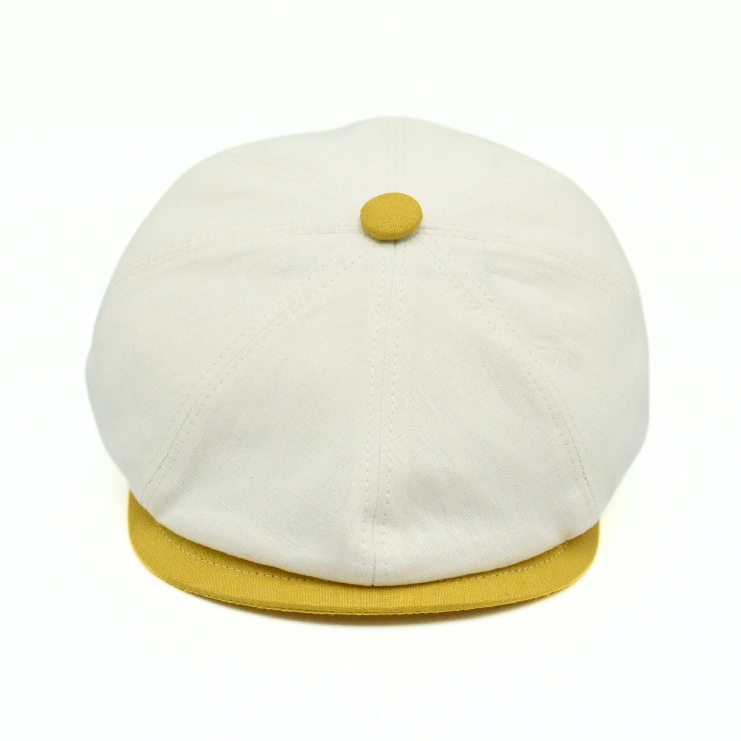 Ivory/Yellow Salerno Linen Newsboy Hat with yellow visor and button on white background