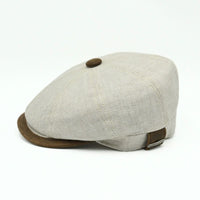 Beige Italian Linen Newsboy Hat with brown leather accents on a white background