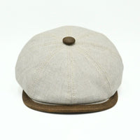 Beige Italian Linen Newsboy Hat with brown leather accents on a white background
