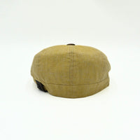mustard Italian Linen Newsboy Hat with leather accents on a white background