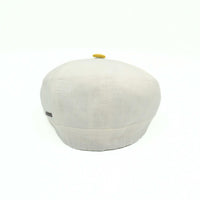 Ivory/Yellow Salerno Linen Newsboy Hat with yellow visor and button on white background