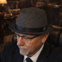Black Royale Pork Pie Hat on model in dark room background