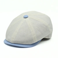 Ivory Salerno Linen Newsboy Hat with blue visor and button on white background