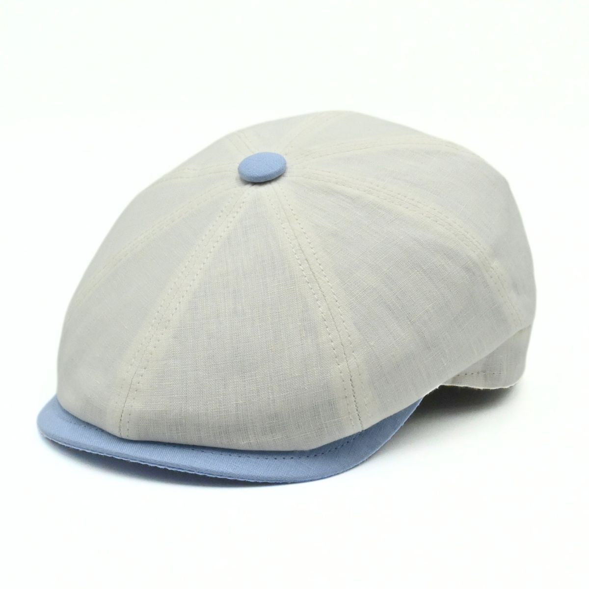 Ivory Salerno Linen Newsboy Hat with blue visor and button on white background