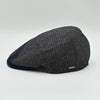 Side view of the Bergamo Cap showing navy and tweed patchwork wool panels