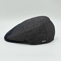 Side view of the Bergamo Cap showing navy and tweed patchwork wool panels