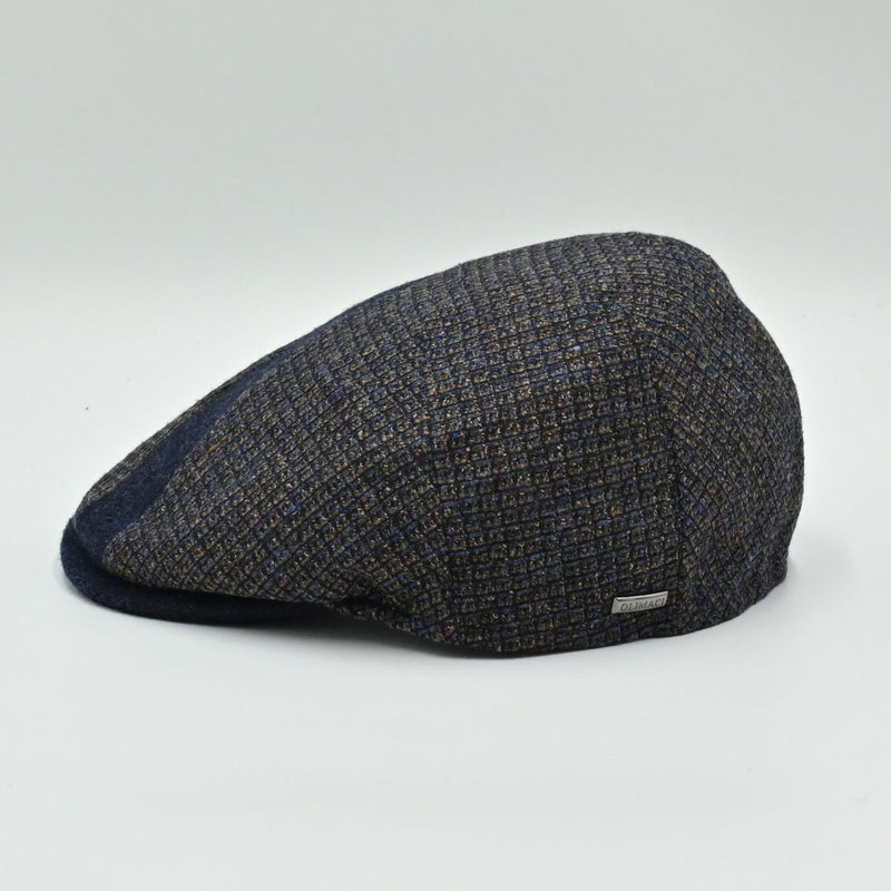 Side view of the Bergamo Cap showing navy and tweed patchwork wool panels